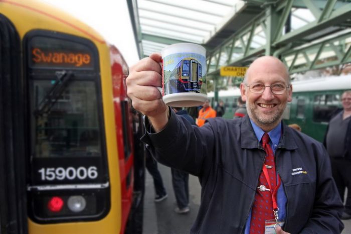 SWT driver Pete Burton and commemorative mug for the Class 159 'Dorset Dominator' excursion from London to the Swanage Railway which ran on 26th October 2013